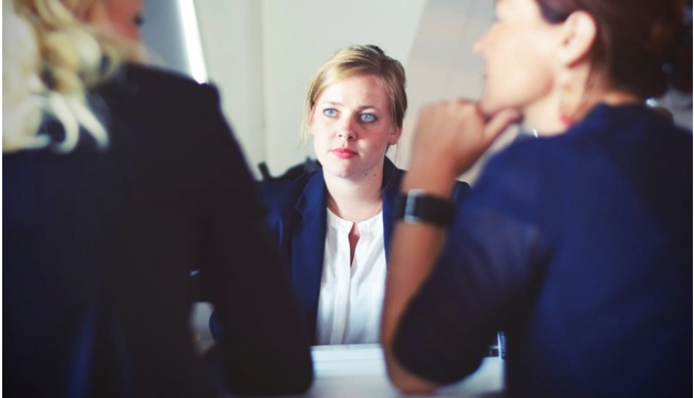 Woman staring to 2 other women